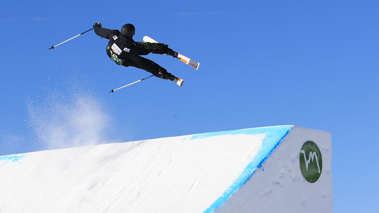 skier jumping over slope