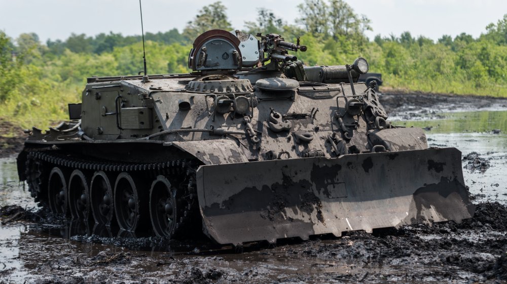 Military vehicle with plow on the front