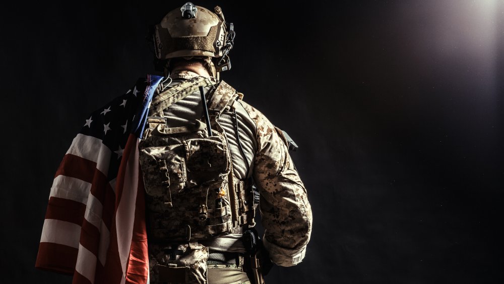 American soldier with gun and flag