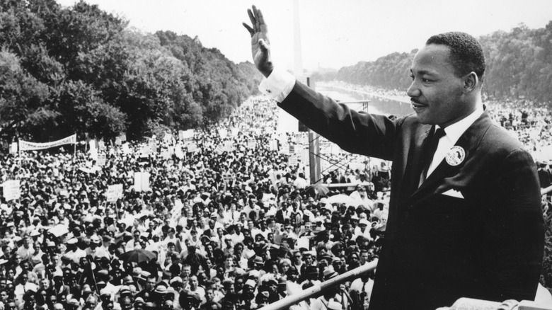 Martin Luther King Jr. waving to crowd