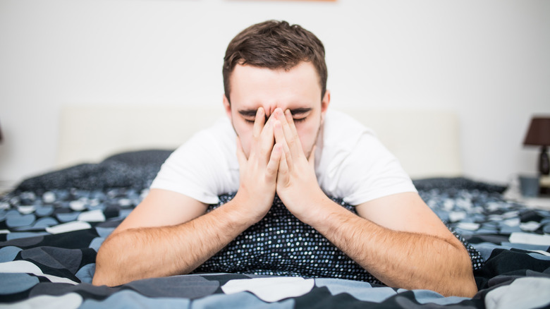 sick man laying on bed