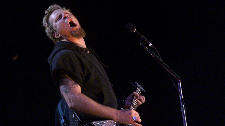 Hetfield mouth open playing guitar