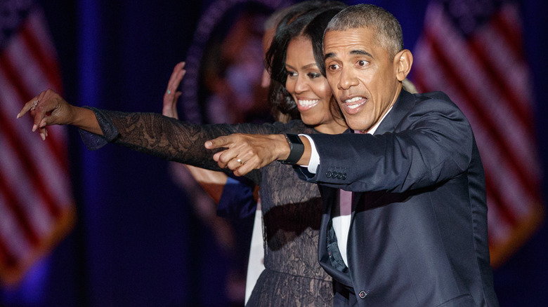 Michelle and Barack Obama pointing