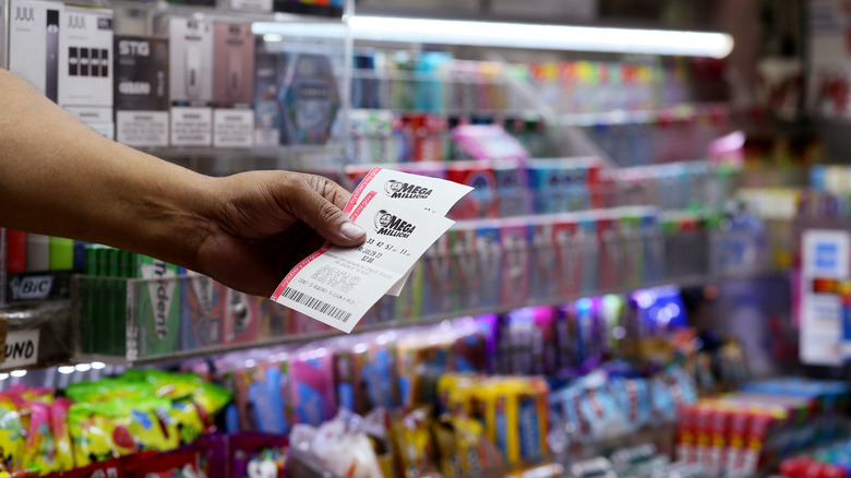 MegaMillions lottery tickets being handed over in a bodega