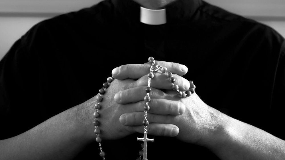 Priest with rosary