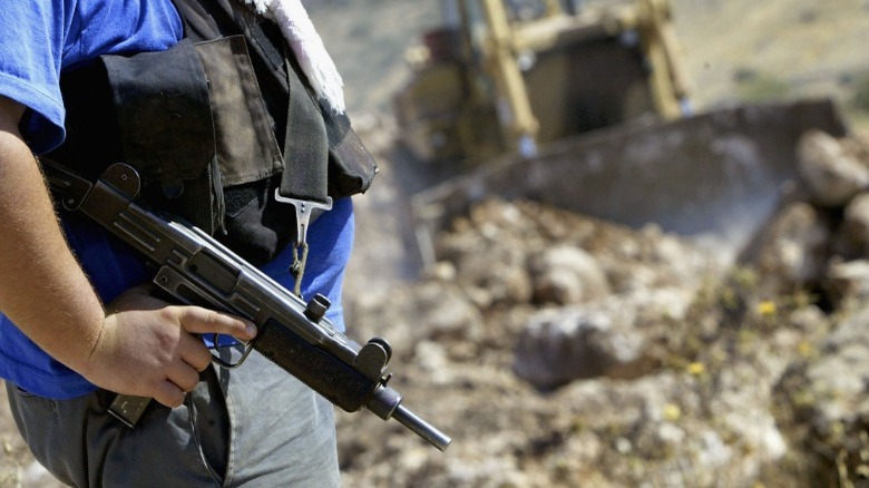 Man holding Uzi in Israel