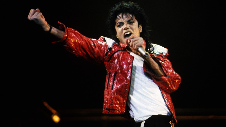 Michael Jackson raising a fist while singing onstage