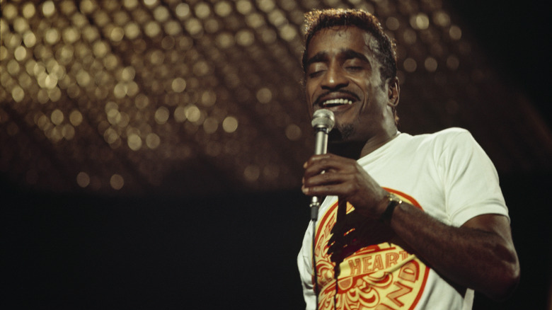 Sammy Davis Jr. singing into microphone