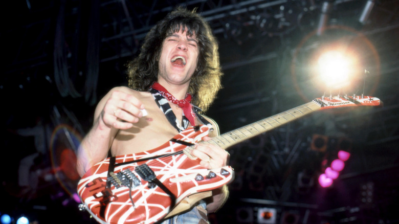 Eddie Van Halen smiling performing onstage