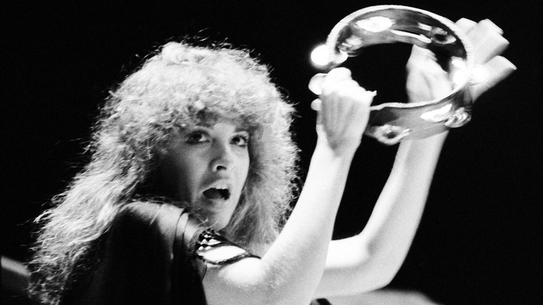 Stevie Nicks playing a tambourine