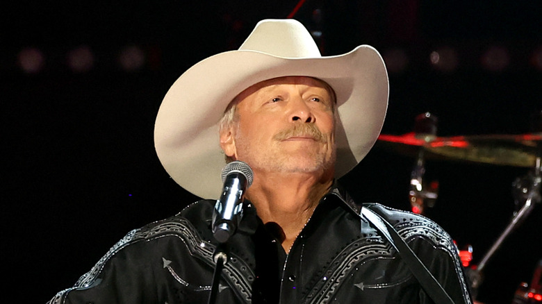 alan jackson singing and playing guitar on stage