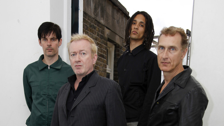 gang of four poses for 2000s publicity shot