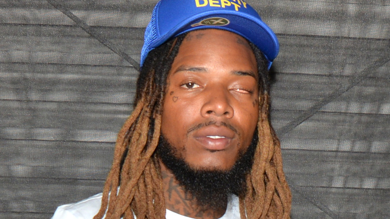 fetty wap looking into camera blue hat