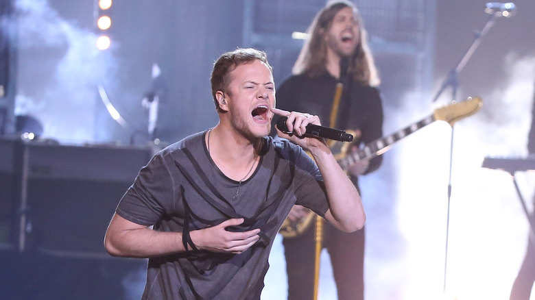 Dan Reynolds on stage holding mic singing