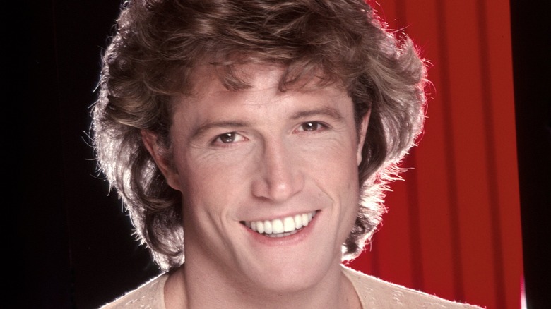 Andy Gibb smiling for portrait