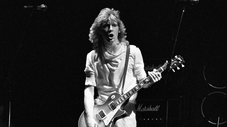 Steve Clark playing guitar onstage