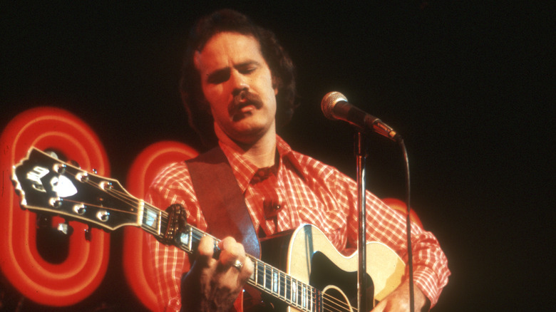 Dave Loggins playing guitar onstage