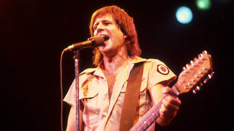 Greg Kihn singing and playing guitar onstage