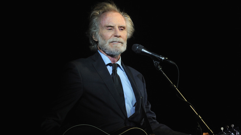 J.D. Souther holding a guitar onstage