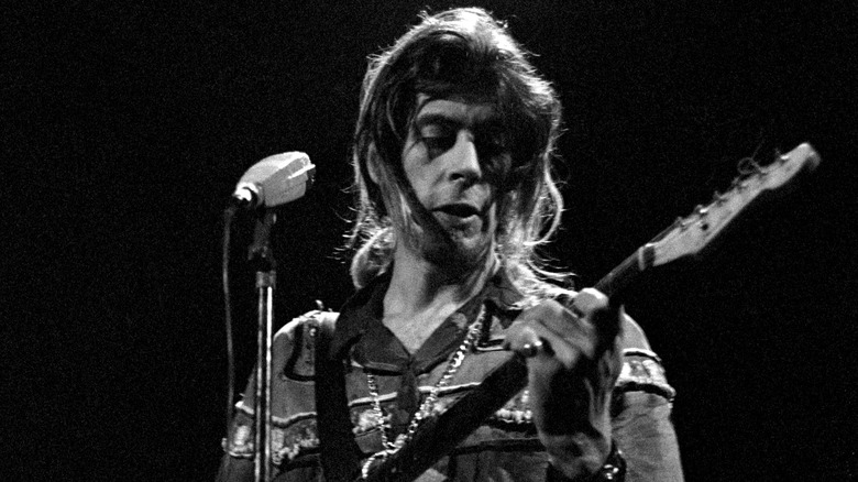 John Mayall playing guitar onstage