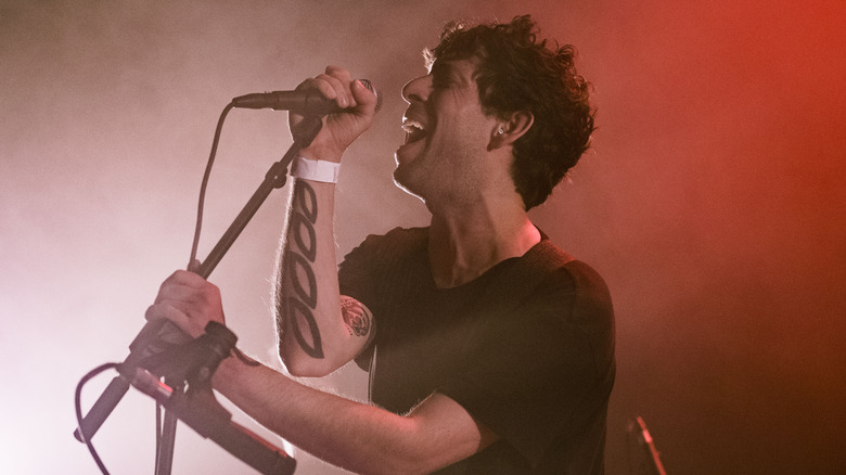 Luis Vasquez singing into a microphone