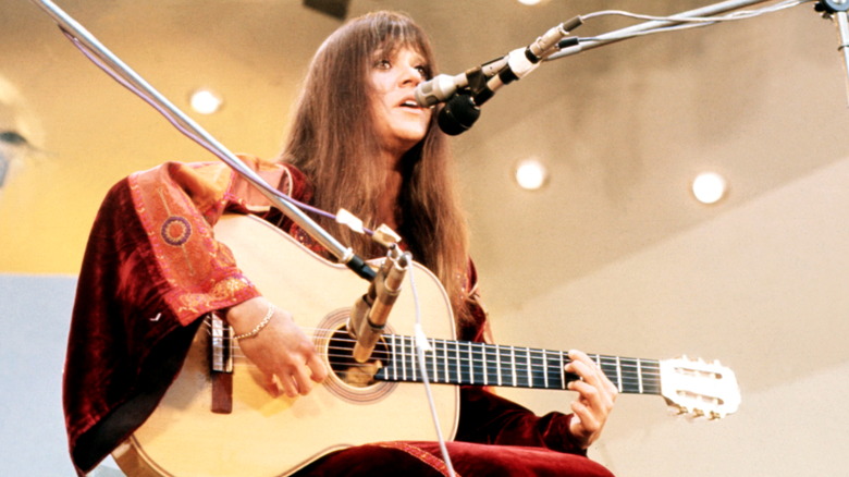 Melanie Safka singing and playing guitar onstage