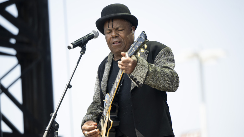 Tito Jackson playing guitar onstage