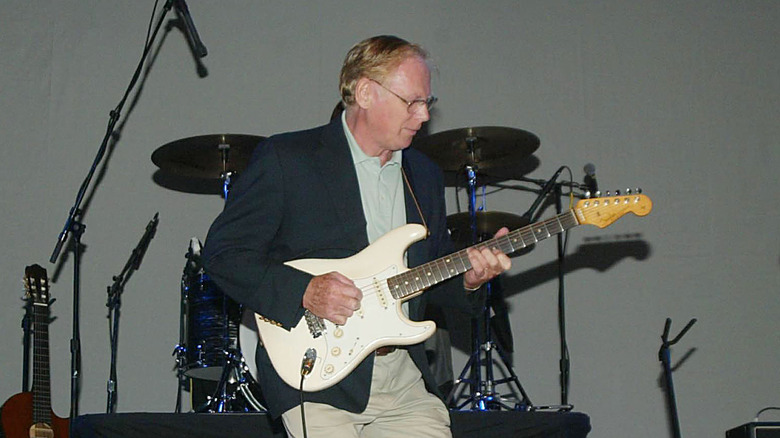 Vic Flick playing guitar onstage