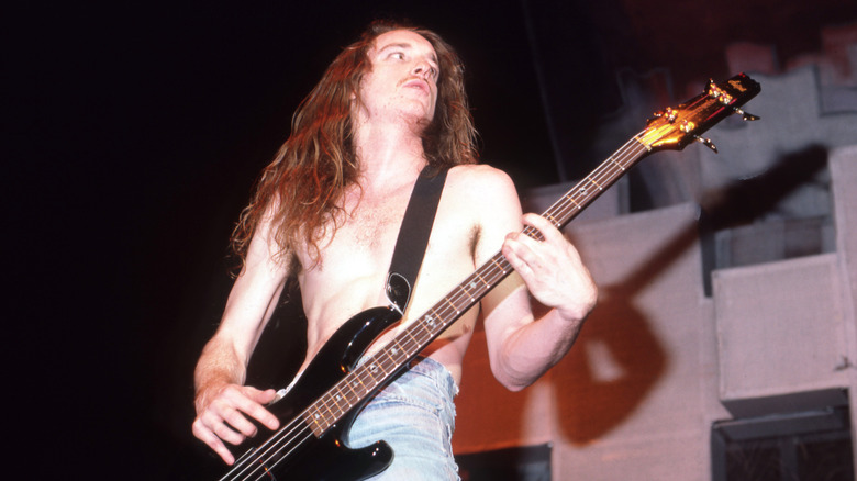 Cliff Burton playing bass while shirtless onstage