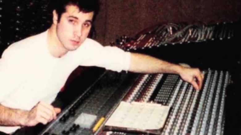 Paul McKasty adjusting the knobs on a mixing board