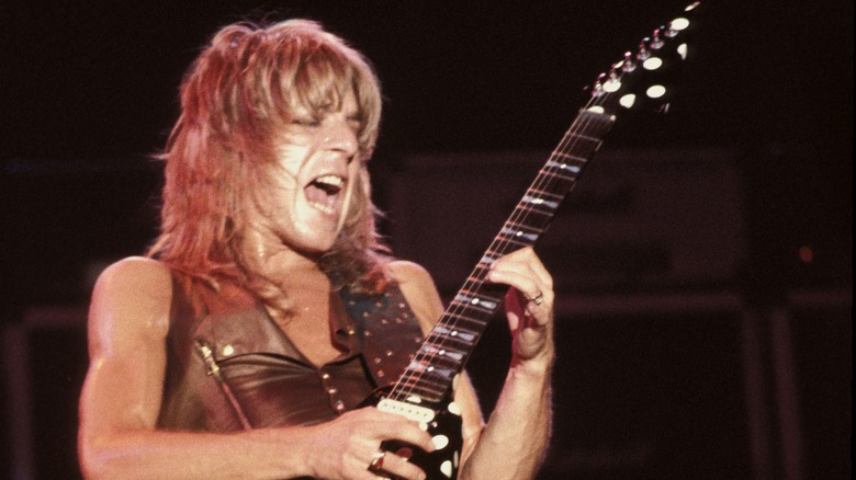 Randy Rhoads with his eyes closed playing a polka dotted guitar