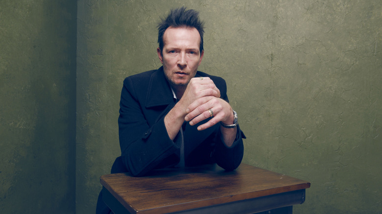 Scott Weiland sitting at a table