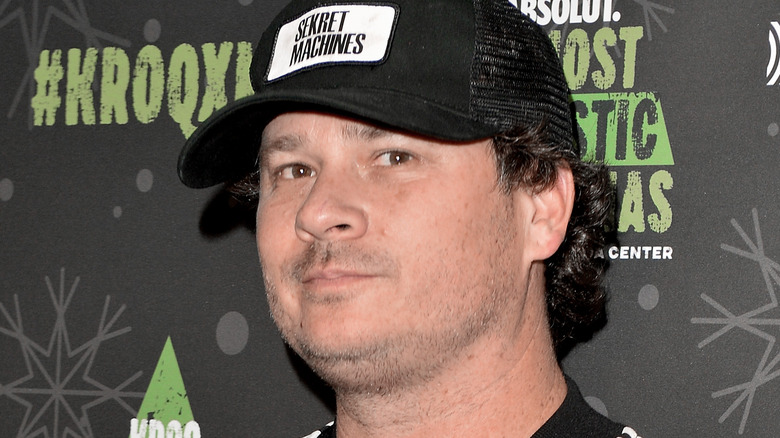 Tom DeLonge wearing black trucker hat