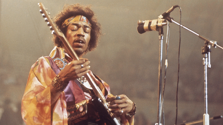 Jimi Hendrix eyes closed playing guitar