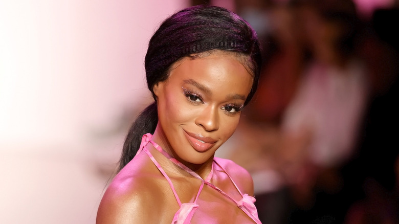 Azealia Banks wearing a pink dress and a ponytail