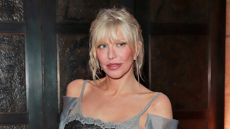 Courtney Love wearing a grey dress 