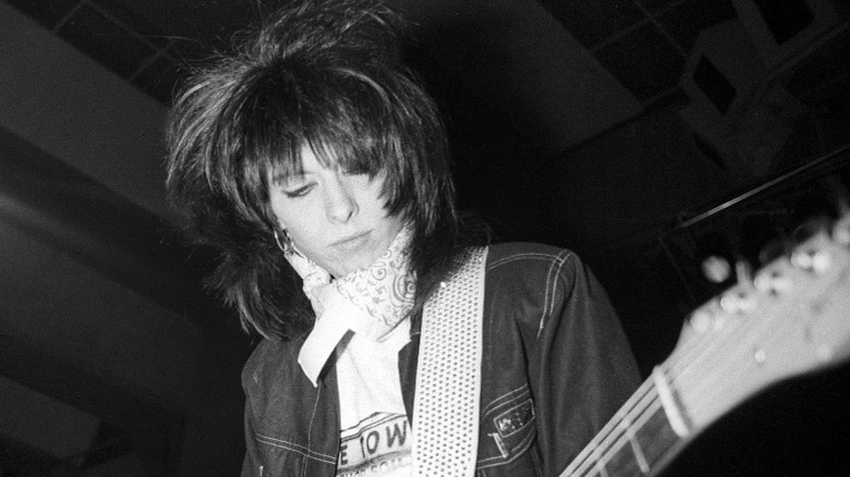 Chrissie Hynde playing guitar black and white