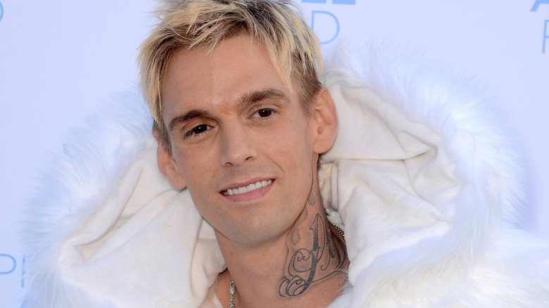 Aaron Carter in a large white coat at event