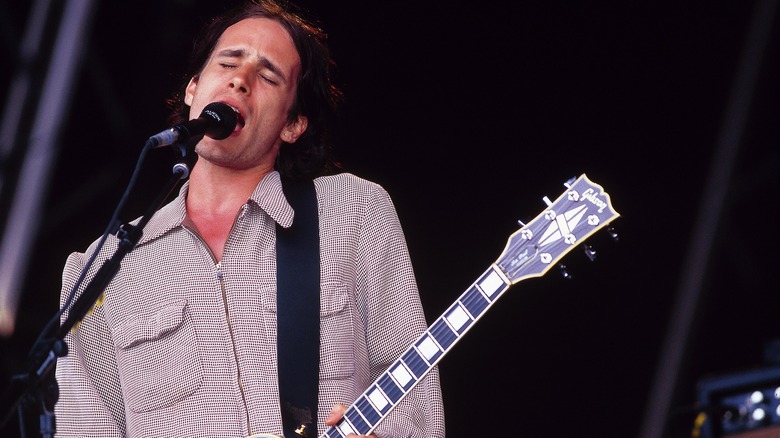 Jeff Buckley singing and playing guitar on stage