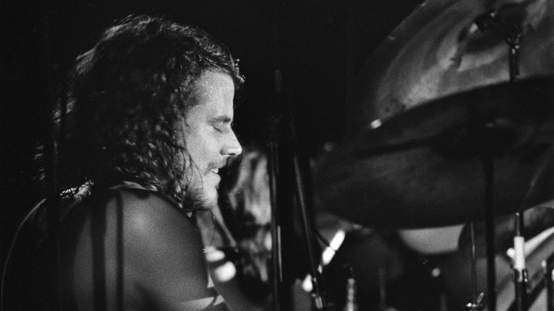 Jim Hodder playing drums profile shot