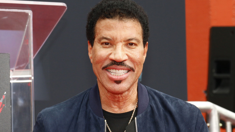 Lionel Richie smiling for photo in 2018