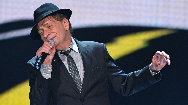 Bobby Caldwell in a fedora performing onstage