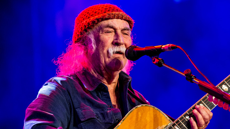 David Crosby playing guitar and singing