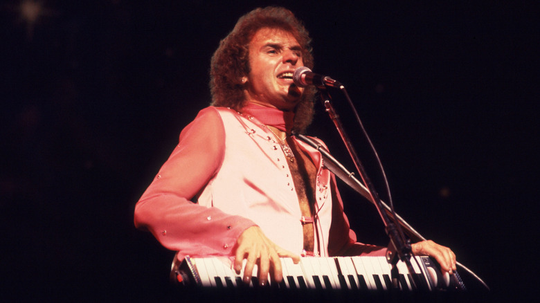 Gary Wright playing a keyboard and singing onstage