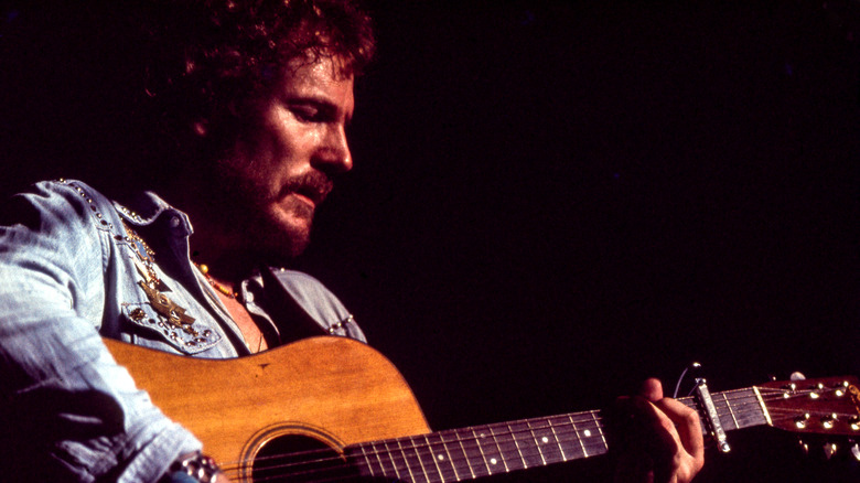 Gordon Lightfoot playing guitar onstage