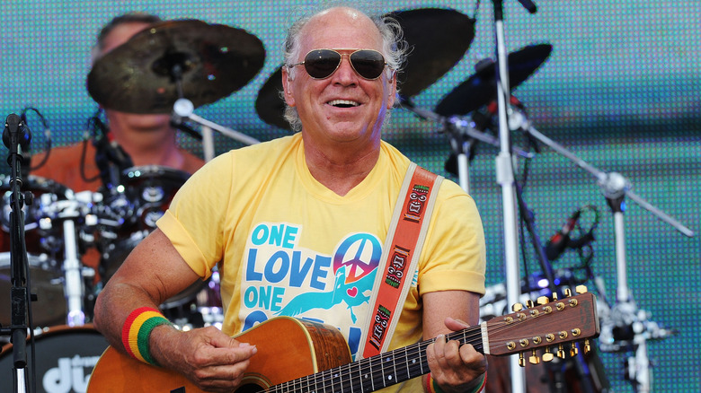 Jimmy Buffett playing guitar onstage