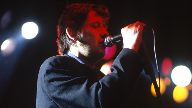 Shane MacGowan singing onstage