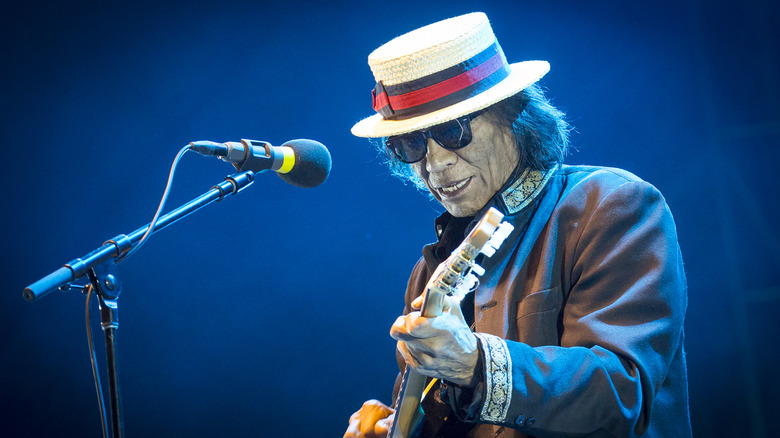 Sixto Rodriguez playing guitar onstage