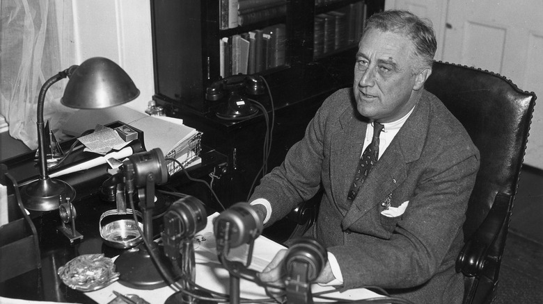 FDR at desk in front of microphones