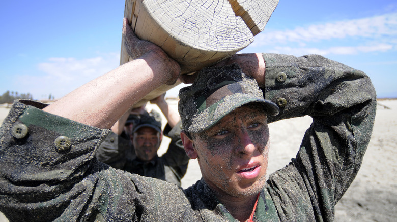 soldiers carry a log